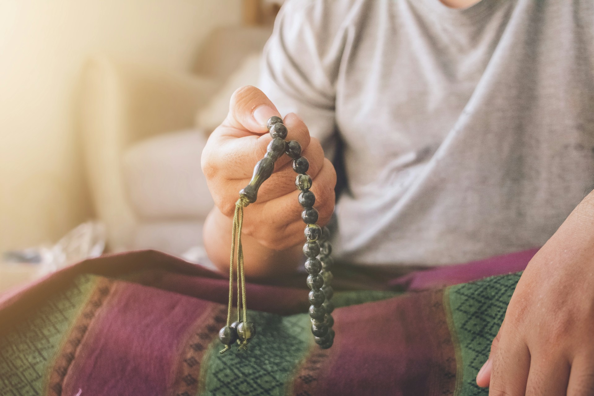 https://unsplash.com/photos/a-man-sitting-on-a-bed-holding-a-beaded-purse-FRgzOVP501E?utm_content=creditShareLink&utm_medium=referral&utm_source=unsplash